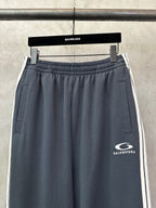 Balenciaga drawstring waist track pants in dark blue with side pockets and logo patch