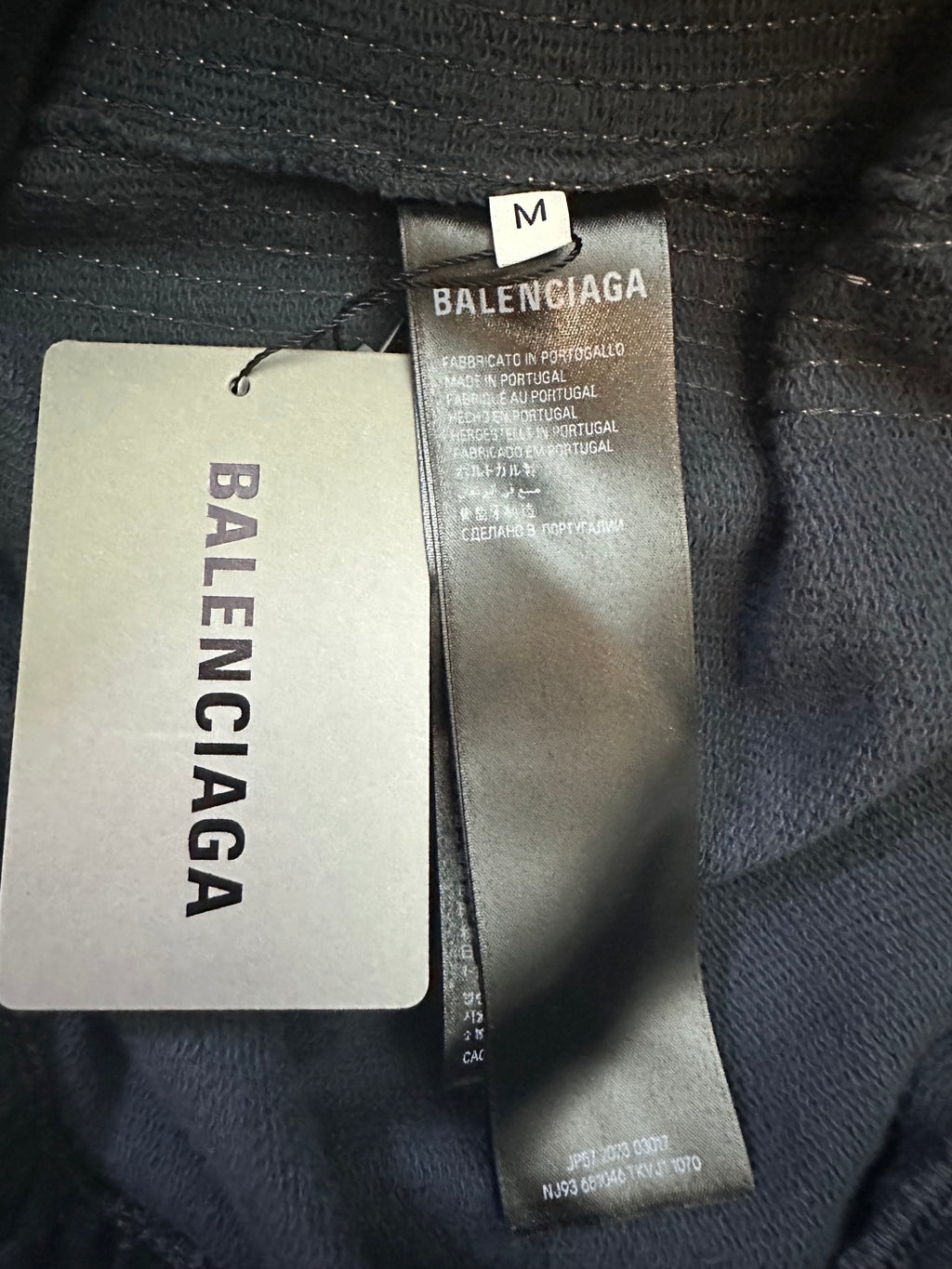 Balenciaga size M fabric label on dark blue track pants hem