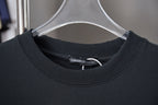 Black crewneck T-shirt with ribbed collar and inner neck label
