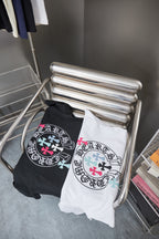 T-shirt pack on rack with white and black tops, both featuring circular logo graphics