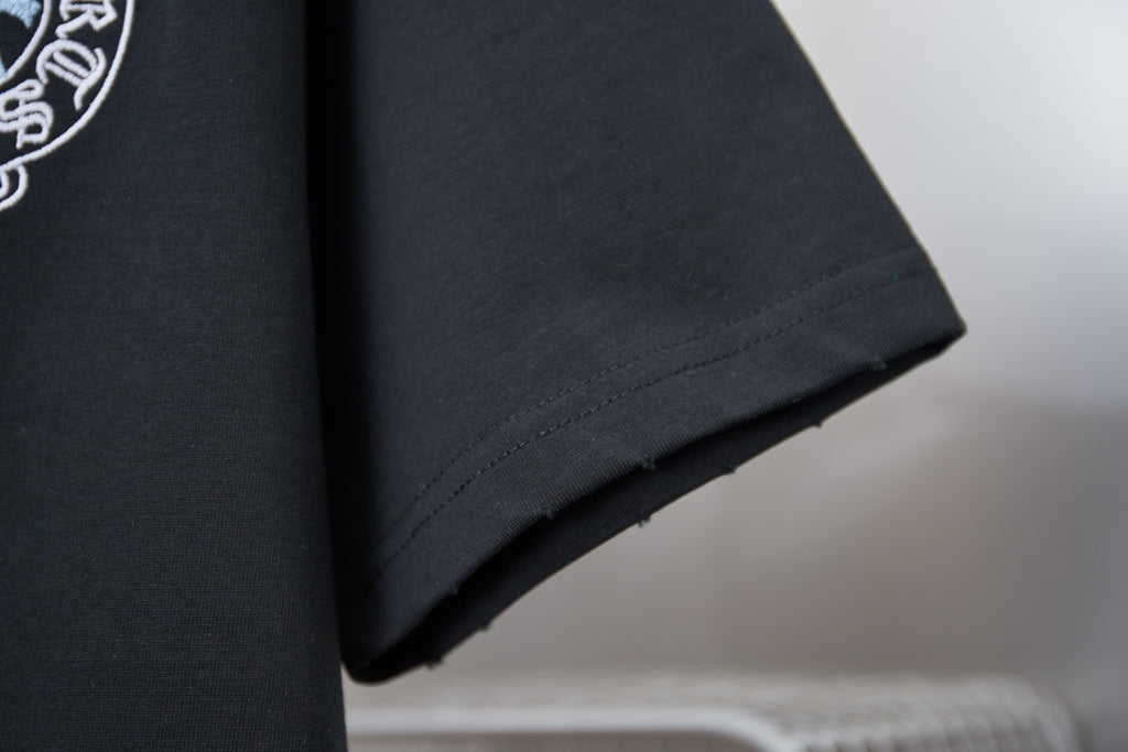 Black T-shirt hem close-up with straight stitching and clean edge