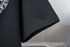 Black T-shirt hem close-up with straight stitching and clean edge