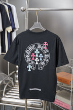Black short-sleeve T-shirt with large circular logo and pink cross detail