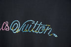 Louis Vuitton T-shirt logo close-up with multicolor rhinestone-style text