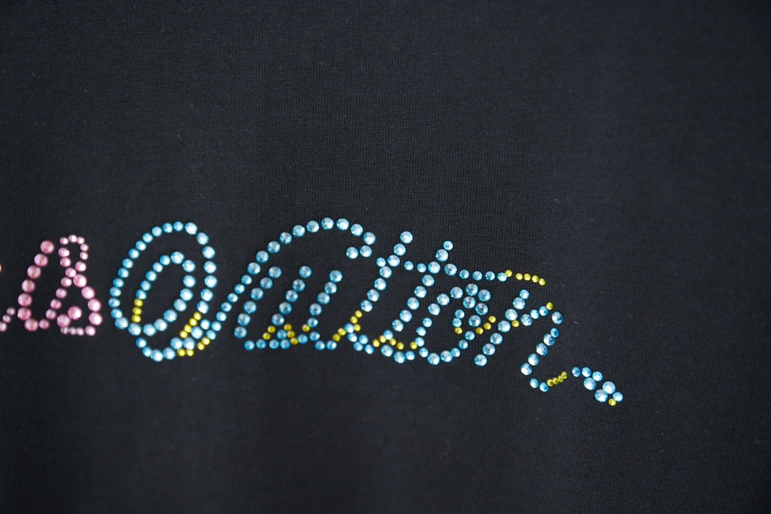 Louis Vuitton T-shirt logo close-up with multicolor rhinestone-style text