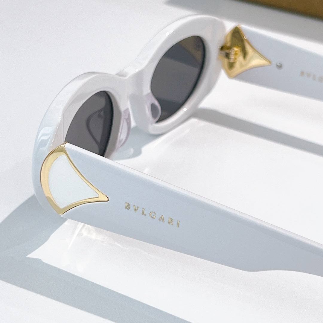 Bvlgari close-up sunglasses, white frames with gold triangular temple accents and dark lenses