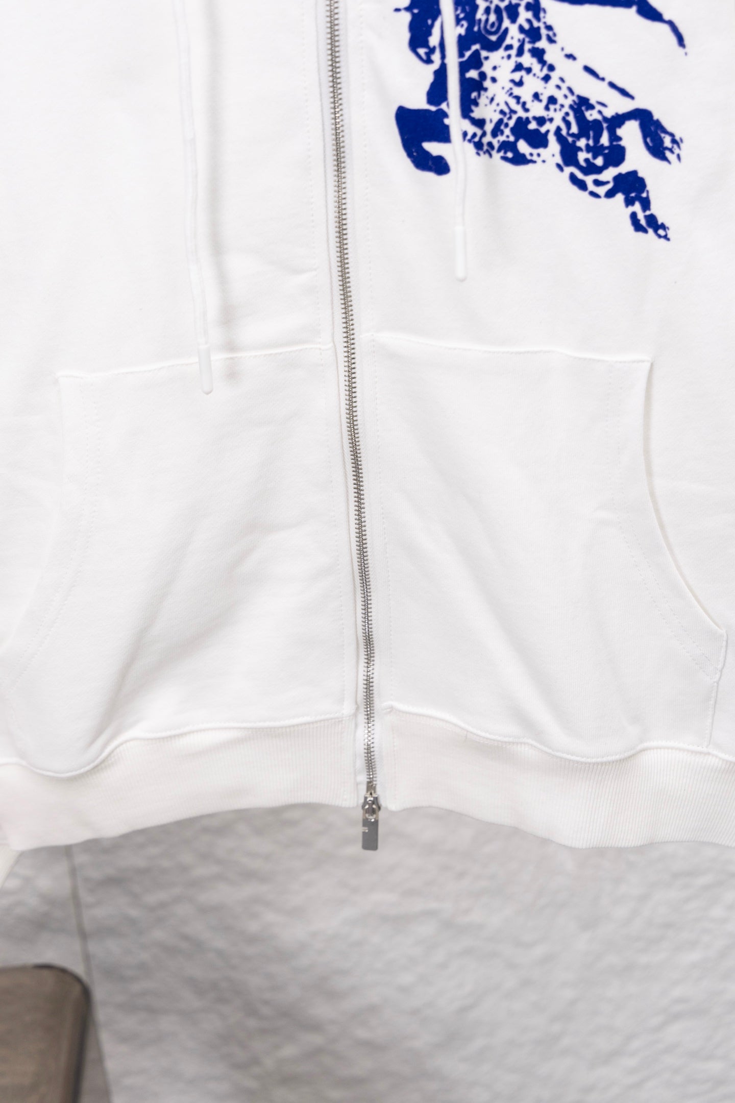White zip-up hoodie with front zipper and kangaroo pocket