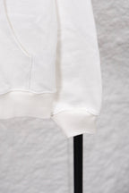 White hoodie cuff area with kangaroo pocket seam