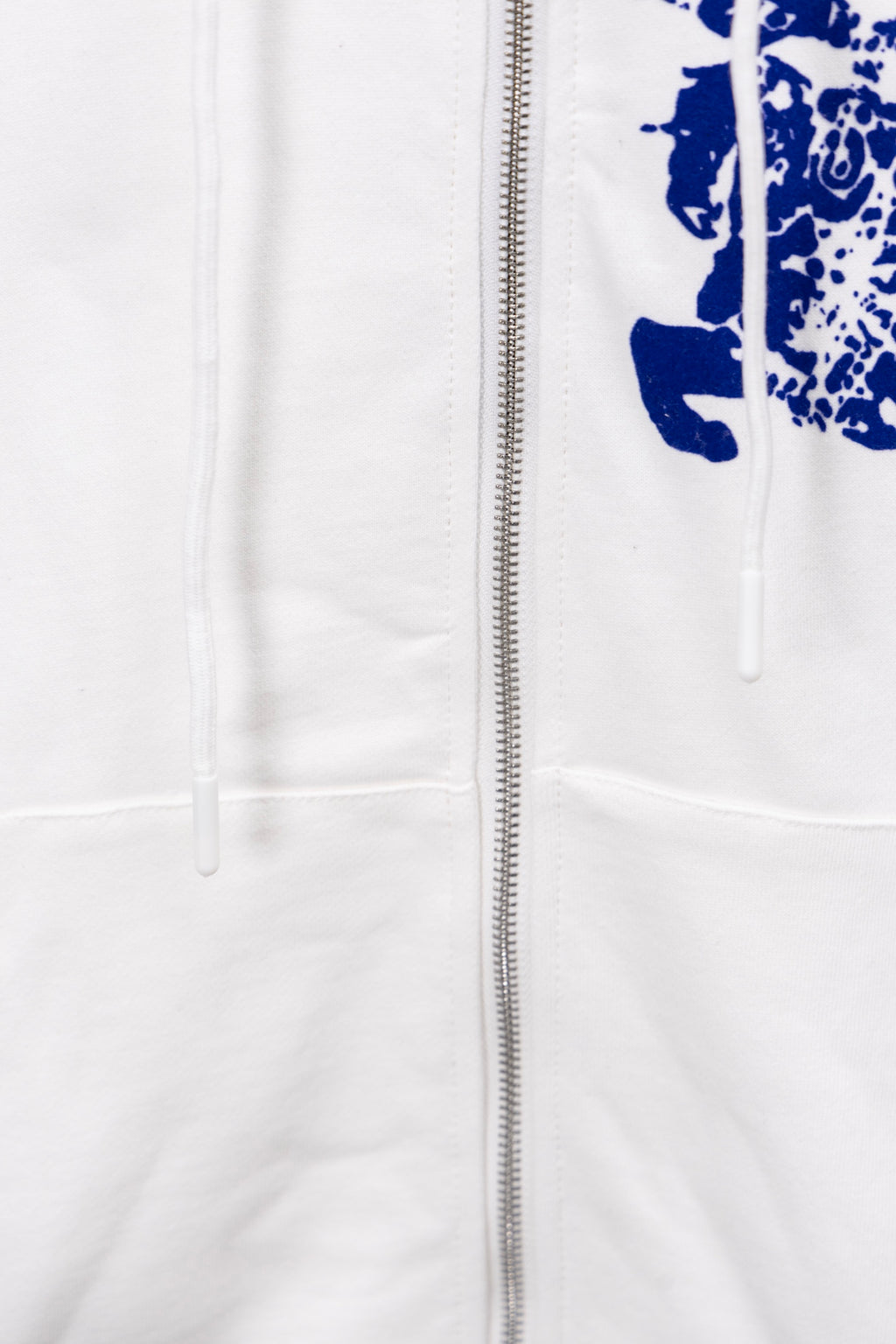 White hoodie with front zipper and blue graphic detail