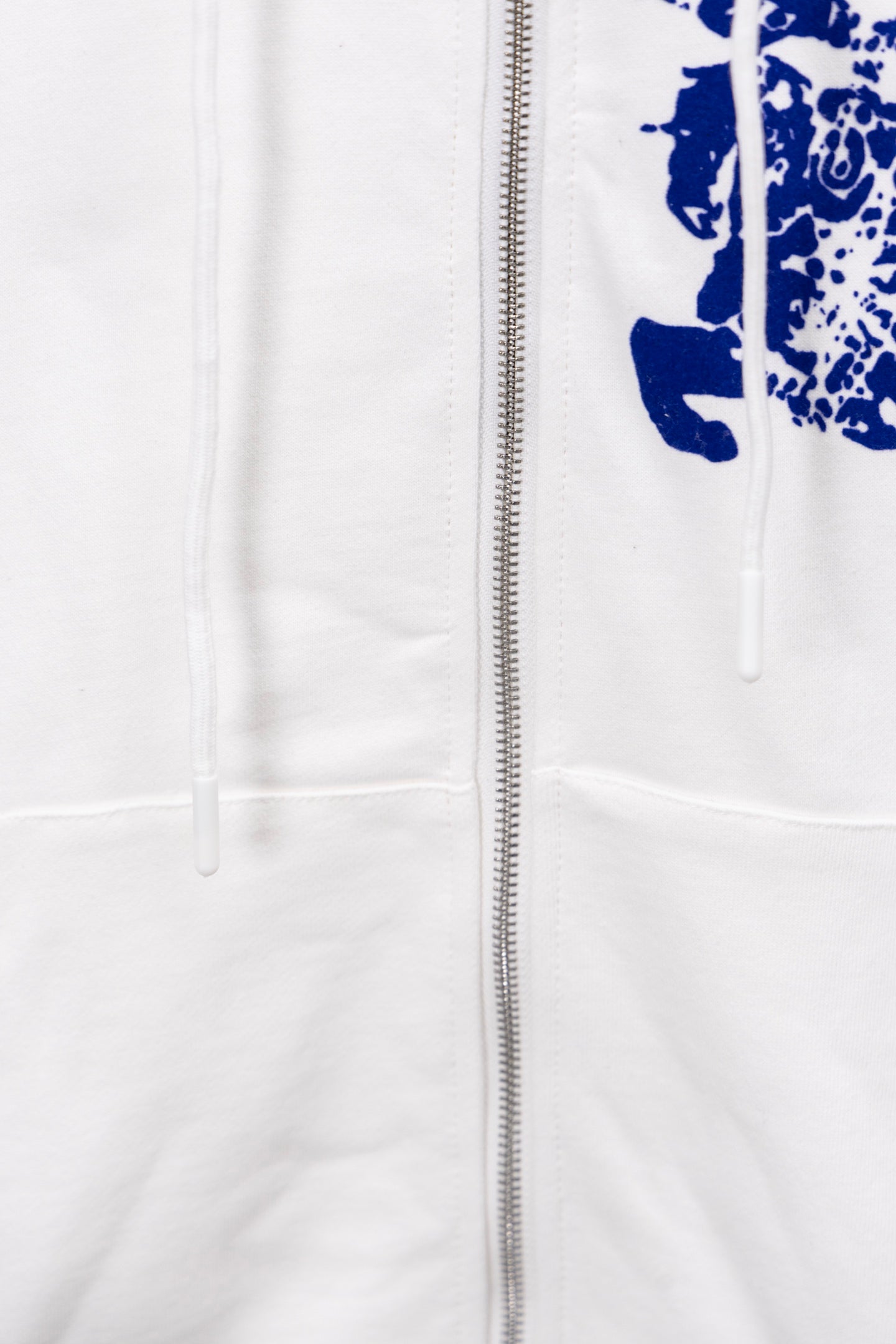 White hoodie with front zipper and blue graphic detail