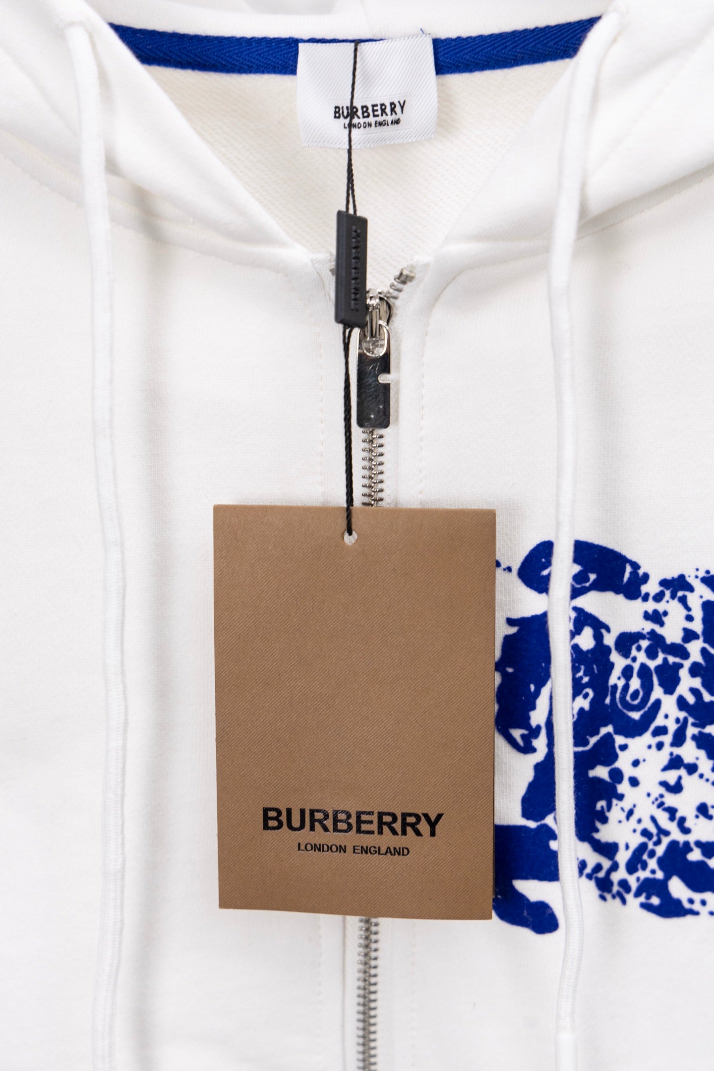 White Burberry hoodie with blue inner hood trim and hang tag on zipper