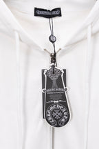 White zip-up hoodie with metallic zipper pull and circular charm necklace detail