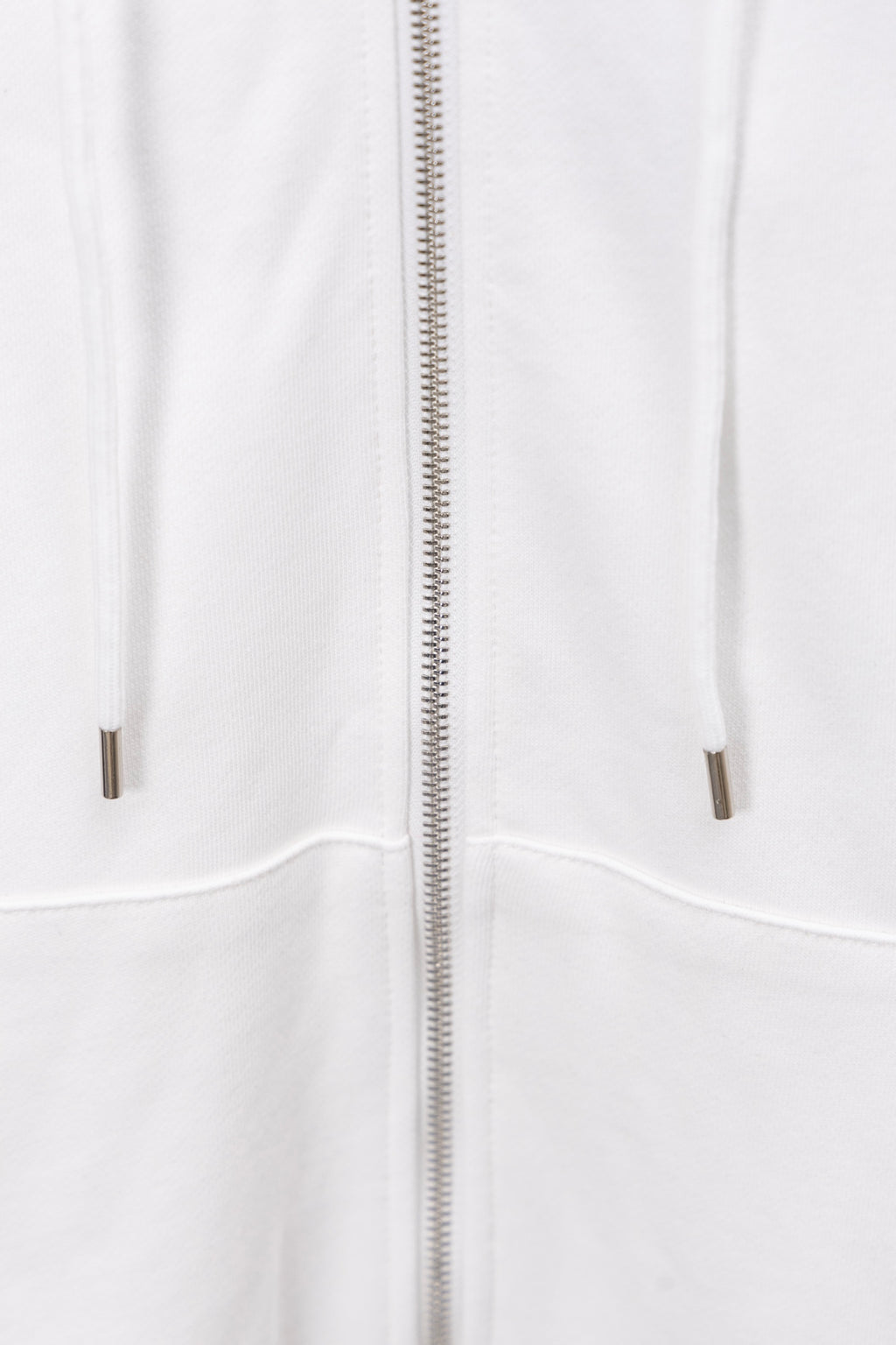 White hoodie front view showing full zip and drawstring-less pockets