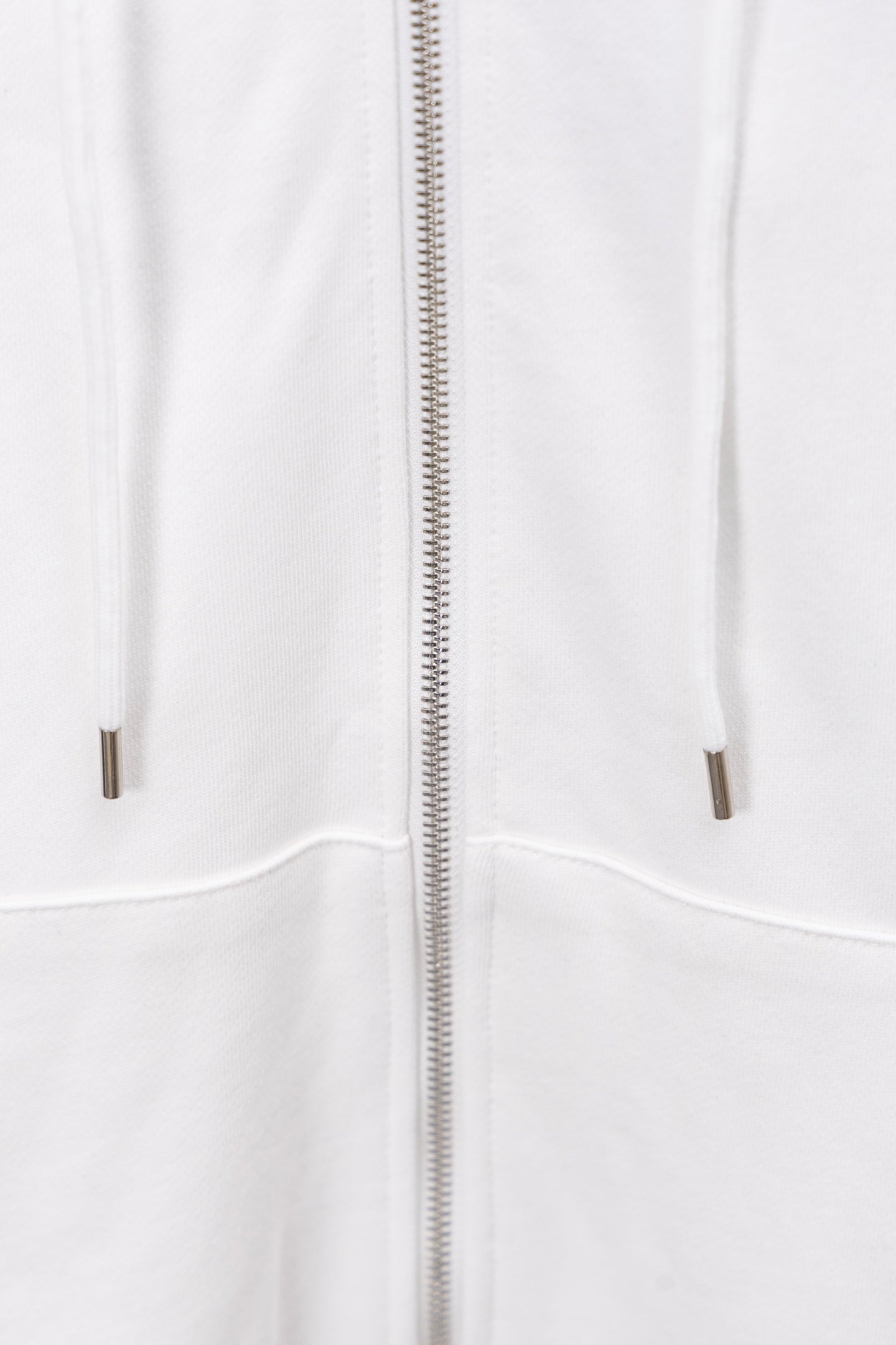 White hoodie front view showing full zip and drawstring-less pockets