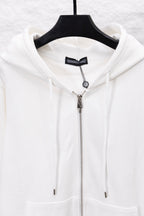 White zip-up hoodie with hood drawstrings and metallic zipper front