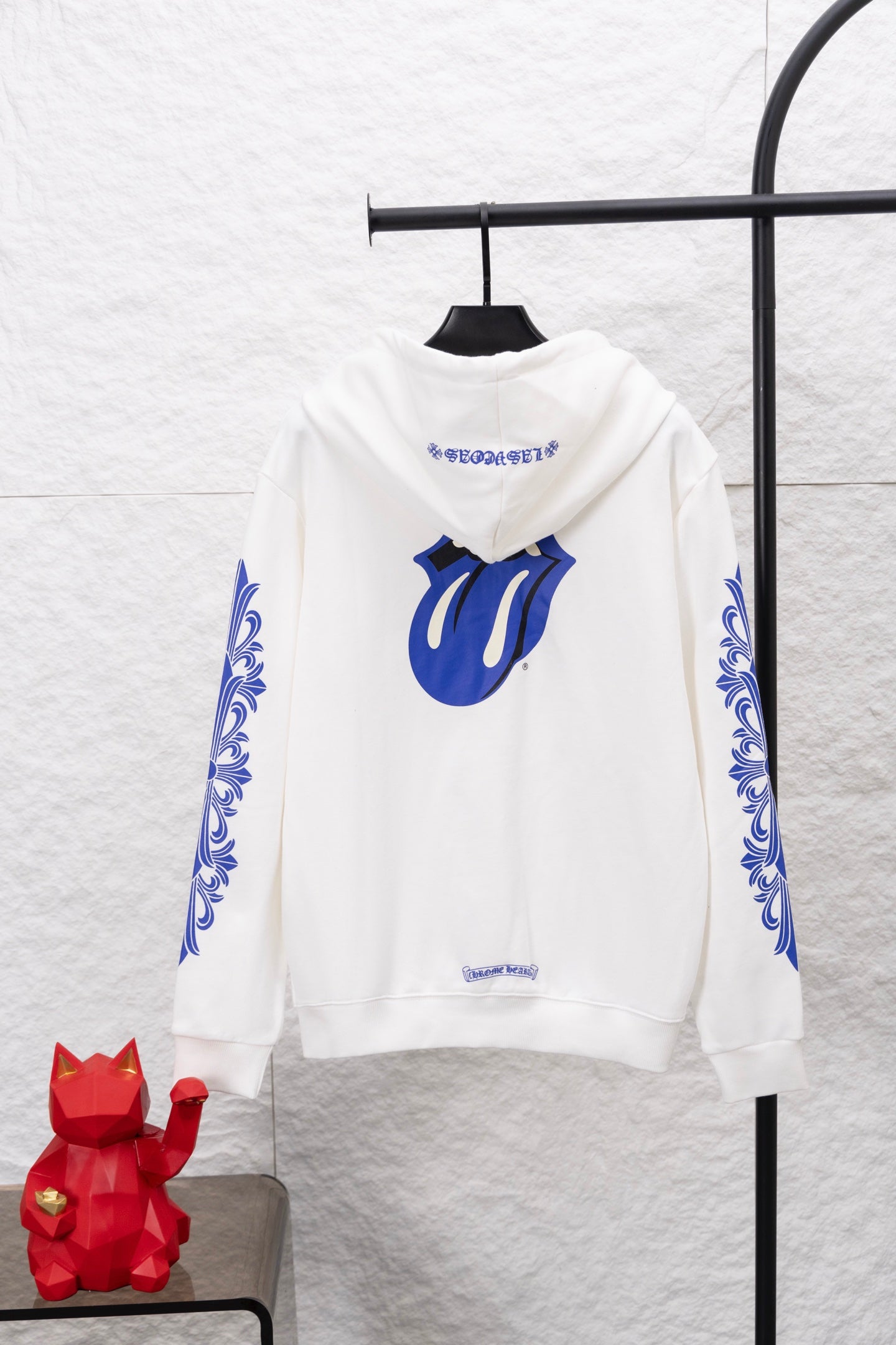 White zip-up hoodie with blue chest graphic and drawstring hood
