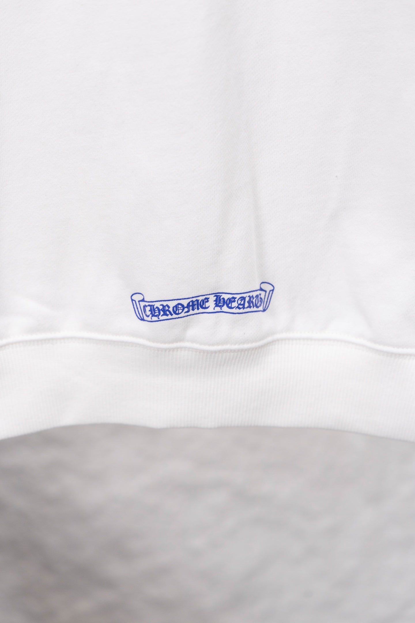 White long-sleeve sweatshirt with blue logo at hem