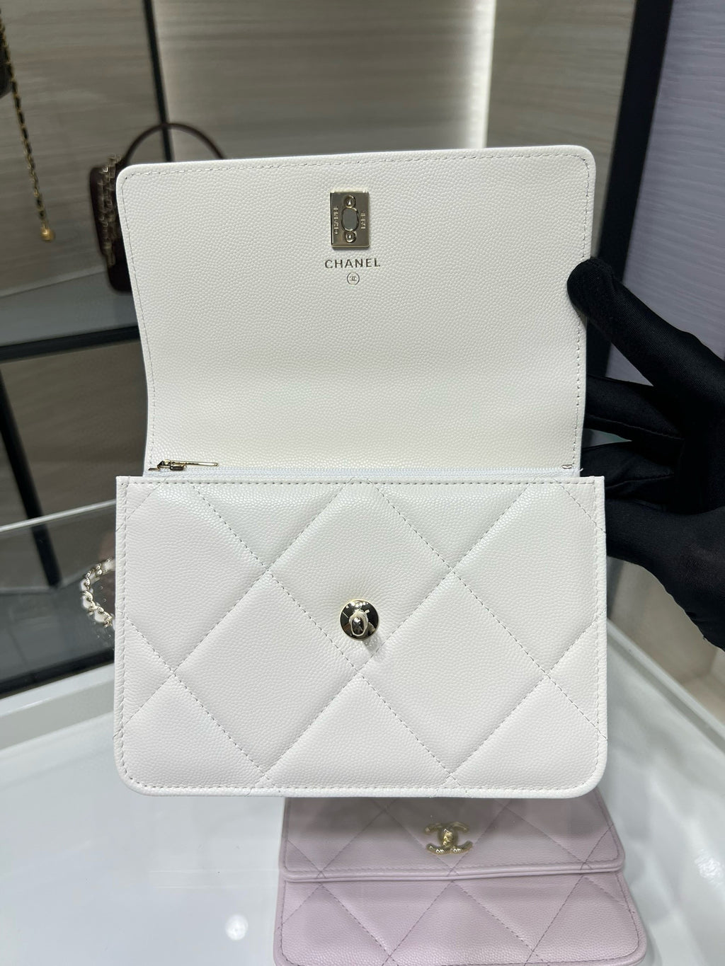 White quilted mini flap bag with top handle and gold CC clasp