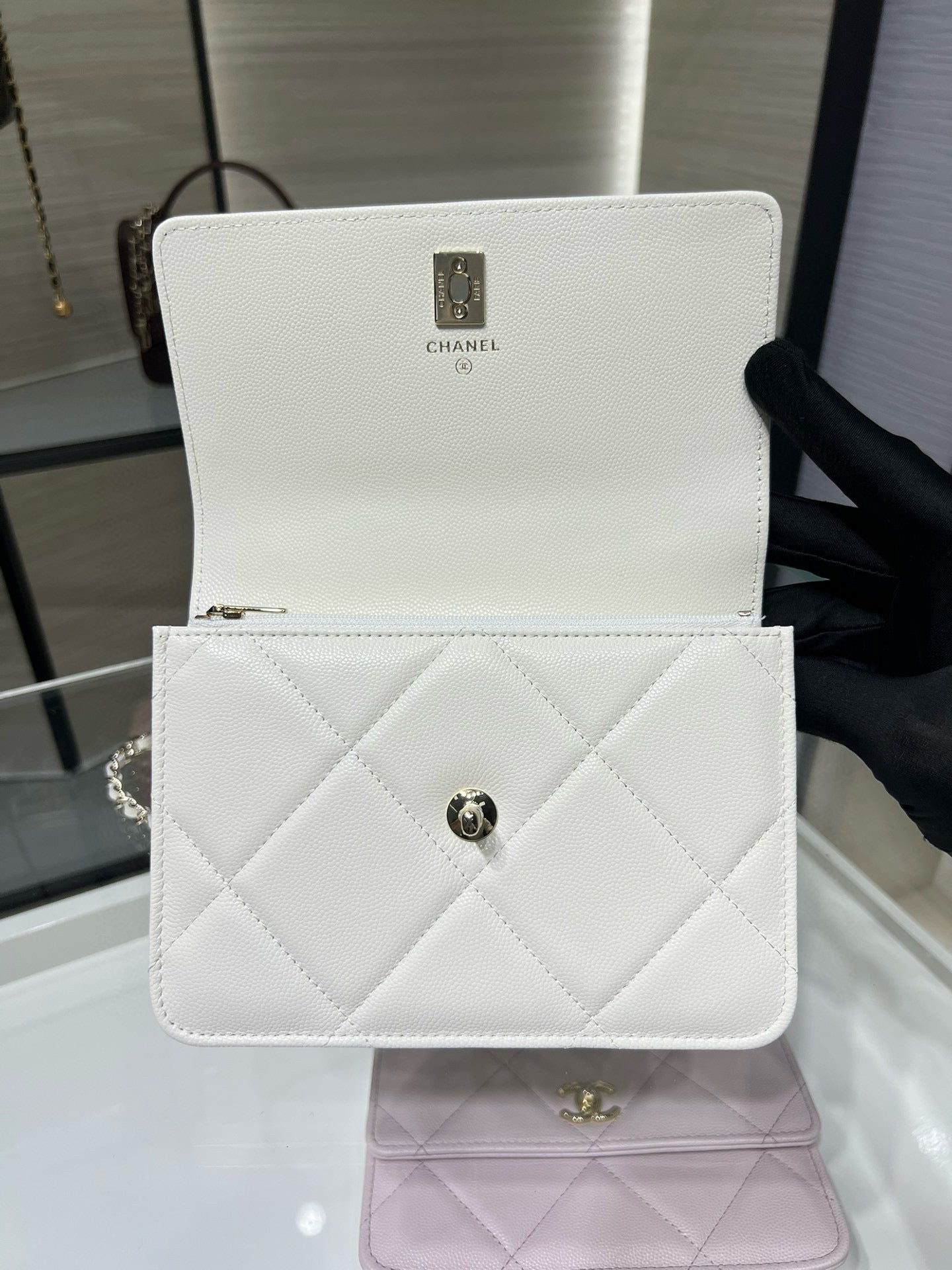 White quilted mini flap bag with top handle and gold CC clasp