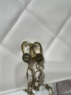 White quilted bag flap with gold ring pull hardware and attached chain links