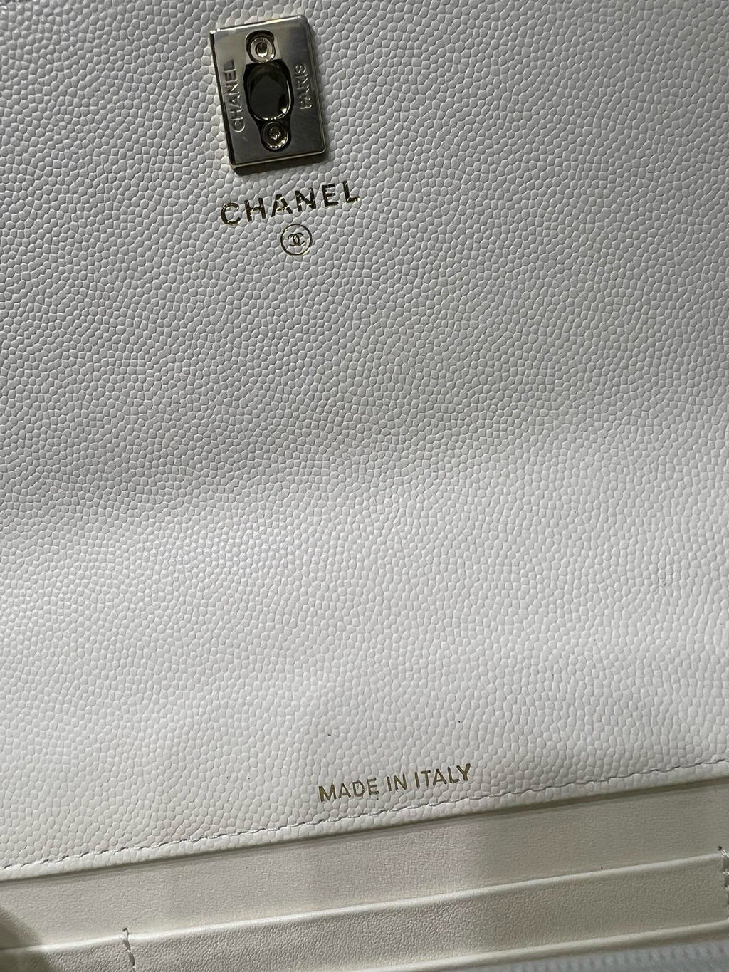 White pebbled leather bag back with Chanel label and "Made in Italy" text