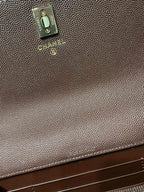Branded metal tab on textured leather bag, taupe tone