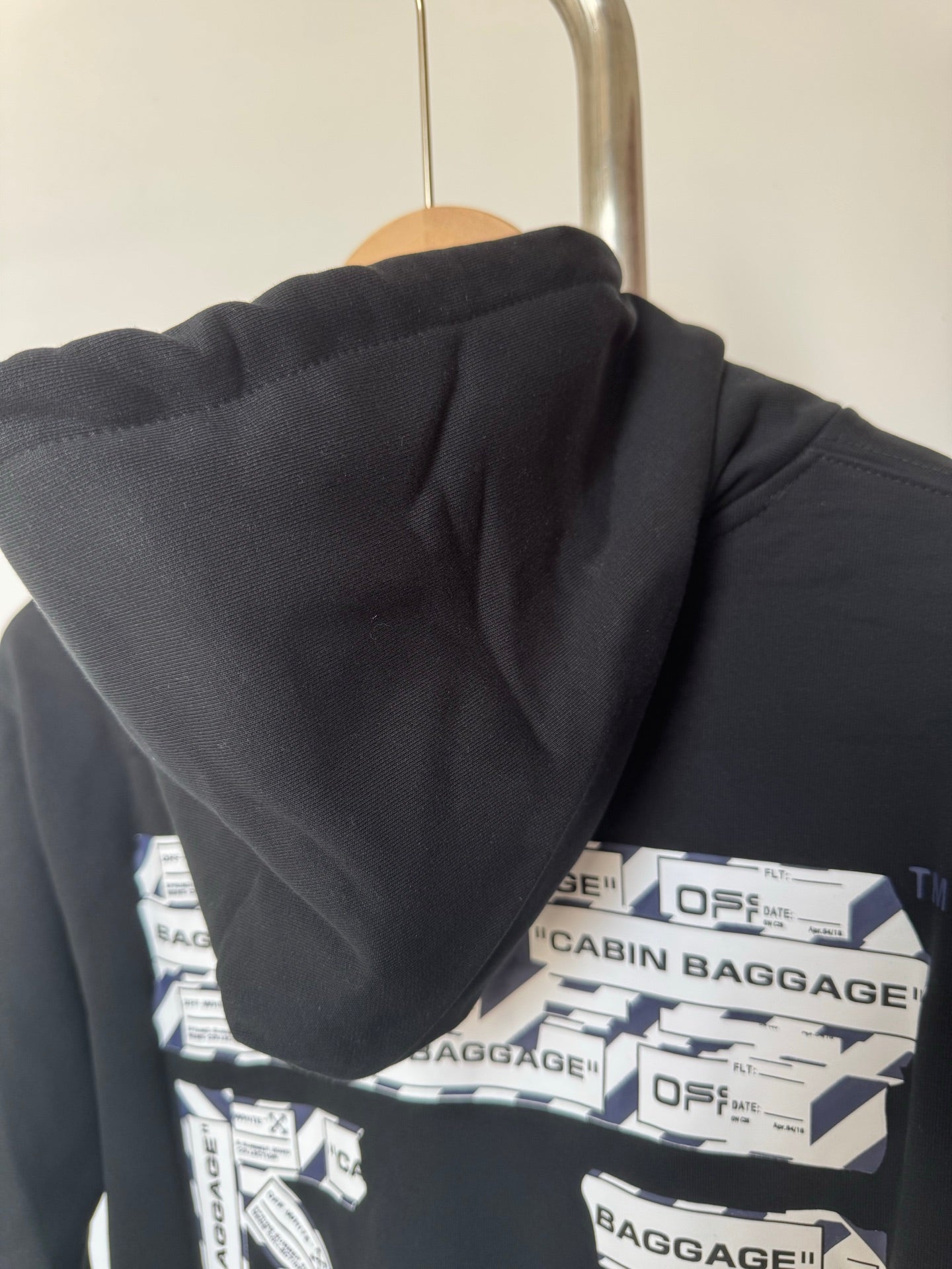 Dark hoodie hood with back graphic print across the shoulders