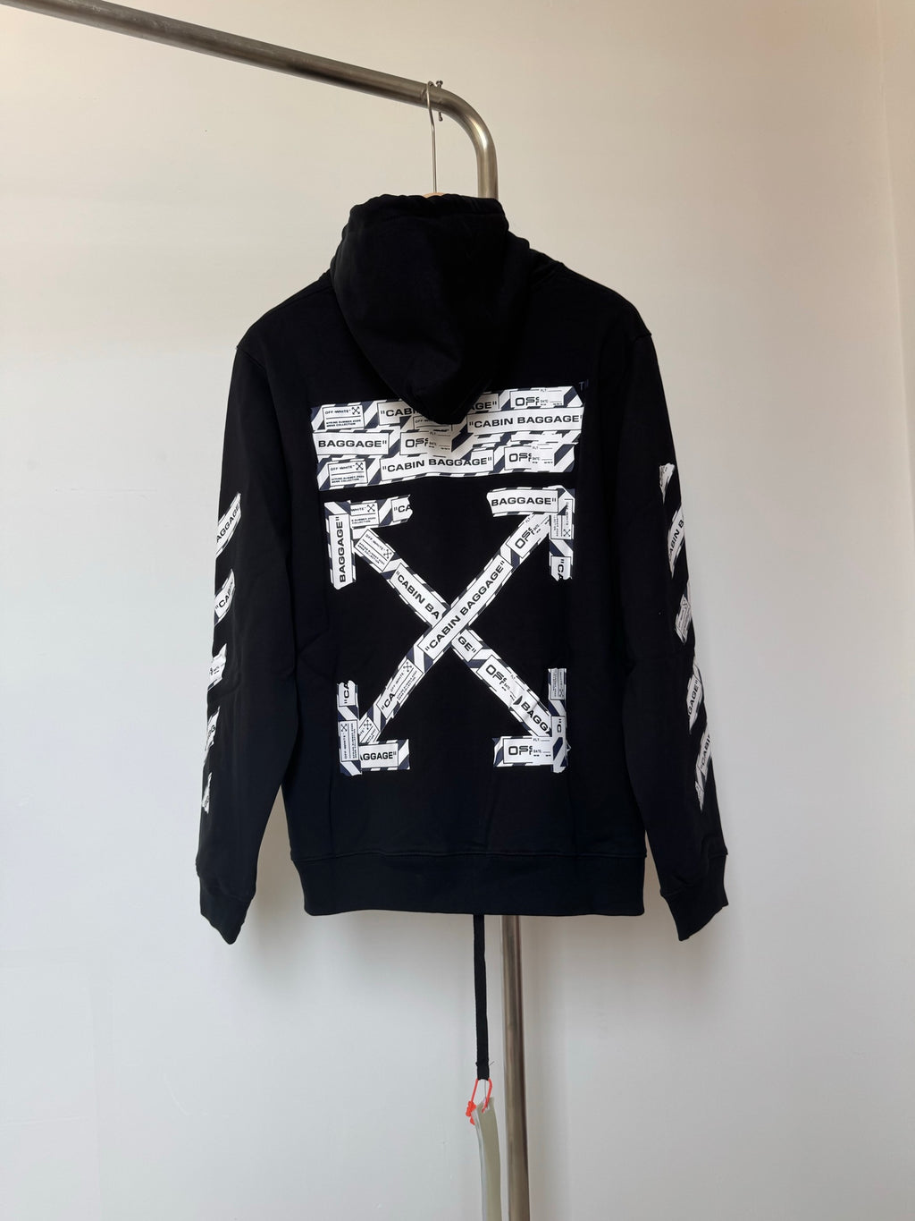 Dark pullover hoodie with large allover geometric graphic on chest