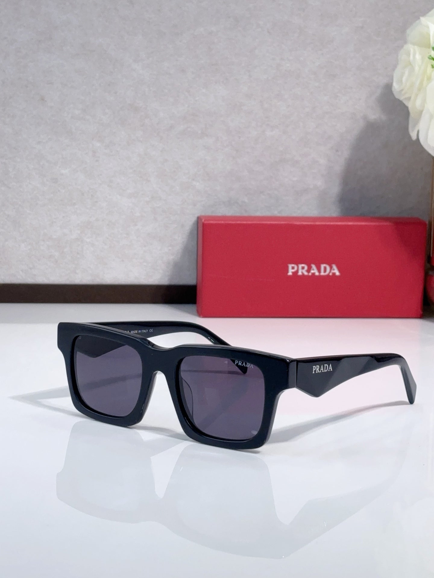 Prada square sunglasses with dark frame and smoky dark-tinted lenses