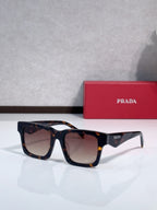 Prada square sunglasses with dark tortoiseshell frame and amber-tinted lenses
