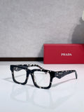 Prada glasses with dark tortoiseshell frames and rectangular lenses.