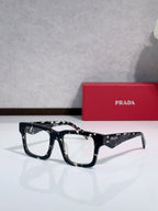 Prada glasses with dark tortoiseshell frames and rectangular lenses.