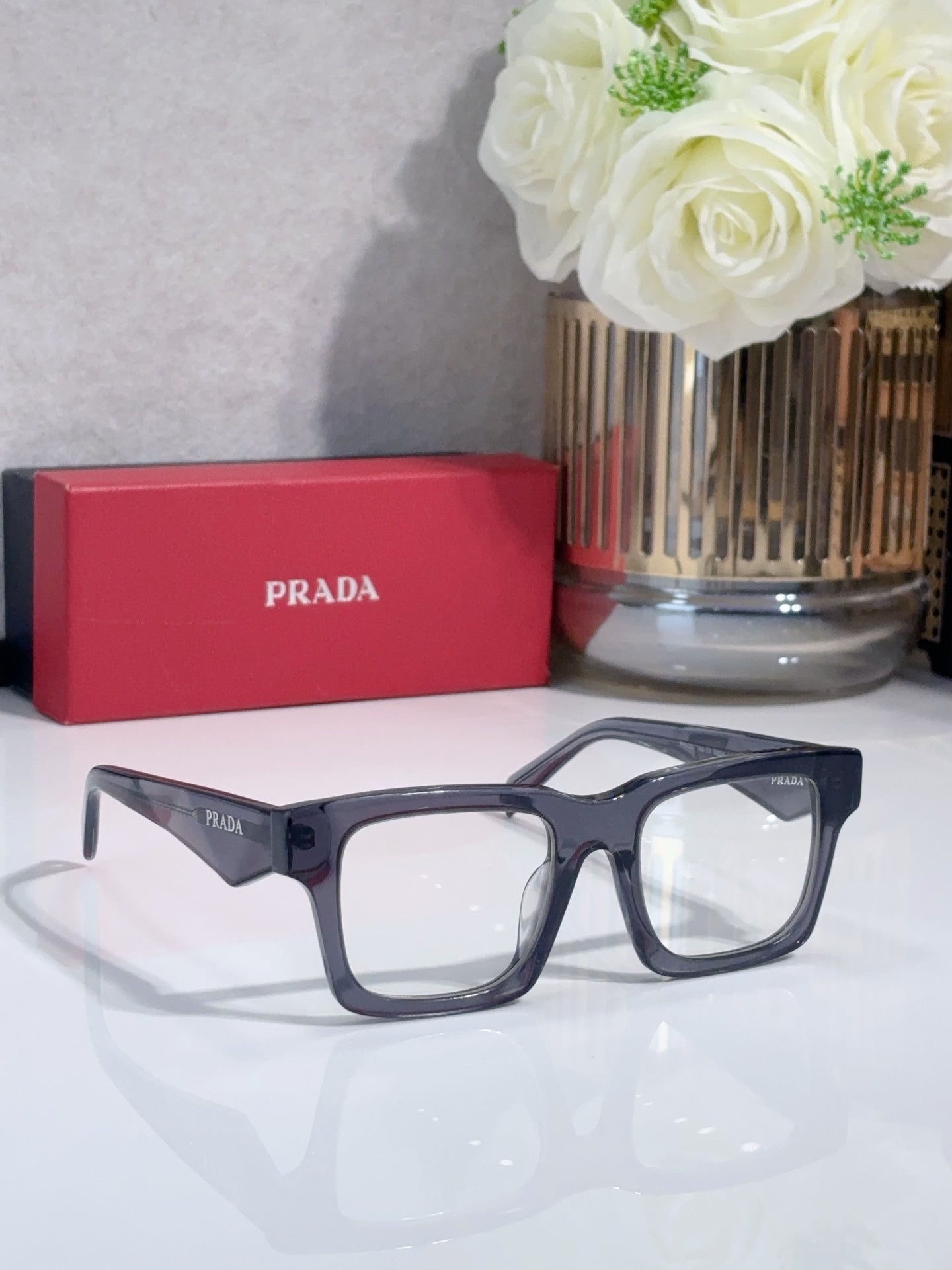 Eyeglasses with navy full-rim frames and rectangular lenses.