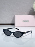 Cat-eye sunglasses with dark lenses and black frames; logo on temple.