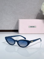 Cat-eye sunglasses with blue frames and dark lenses; logo on temple.