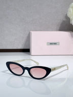 Cat-eye sunglasses with pink-tinted lenses and black frames; logo on temple.