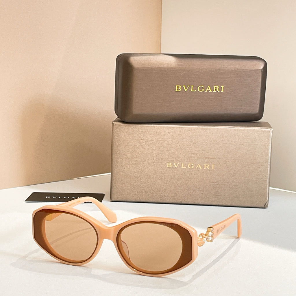 Light tan sunglasses with amber-tinted lenses and embellished temple detail