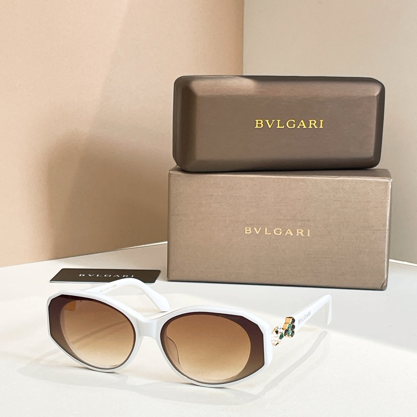 White sunglasses with tinted lenses and embellished temple detail