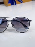 Louis Vuitton round sunglasses close-up with black frame and dark gradient tinted lenses