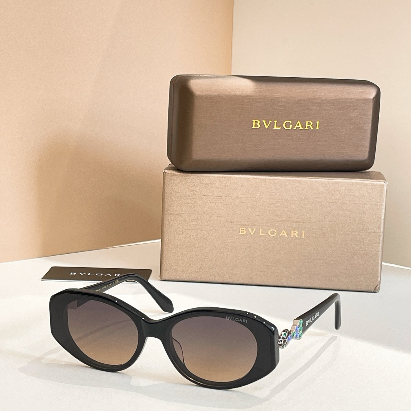 Black sunglasses with dark-tinted lenses and embellished temple detail