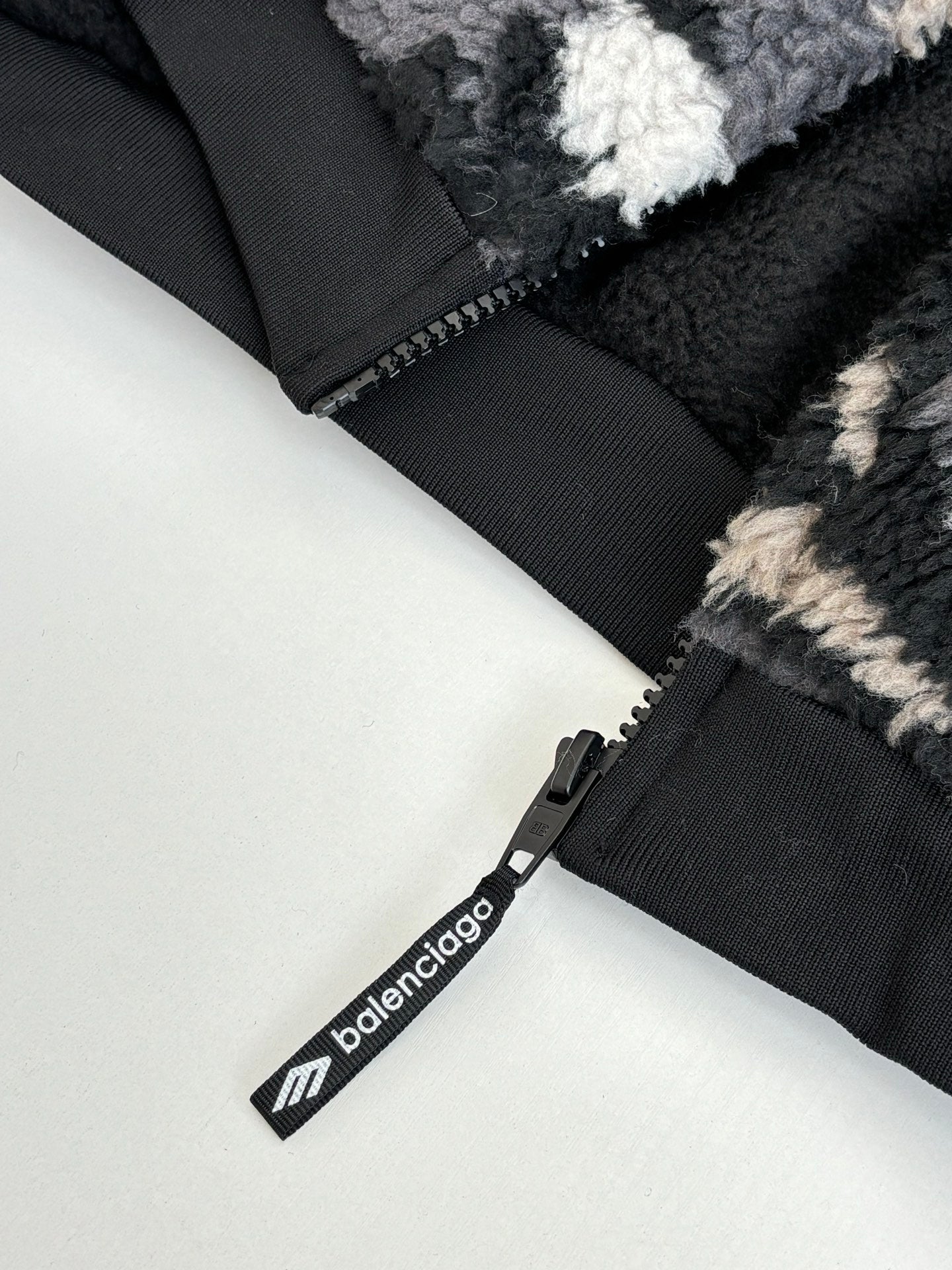 Balenciaga fleece jacket zipper and pull tab, black with white logo text