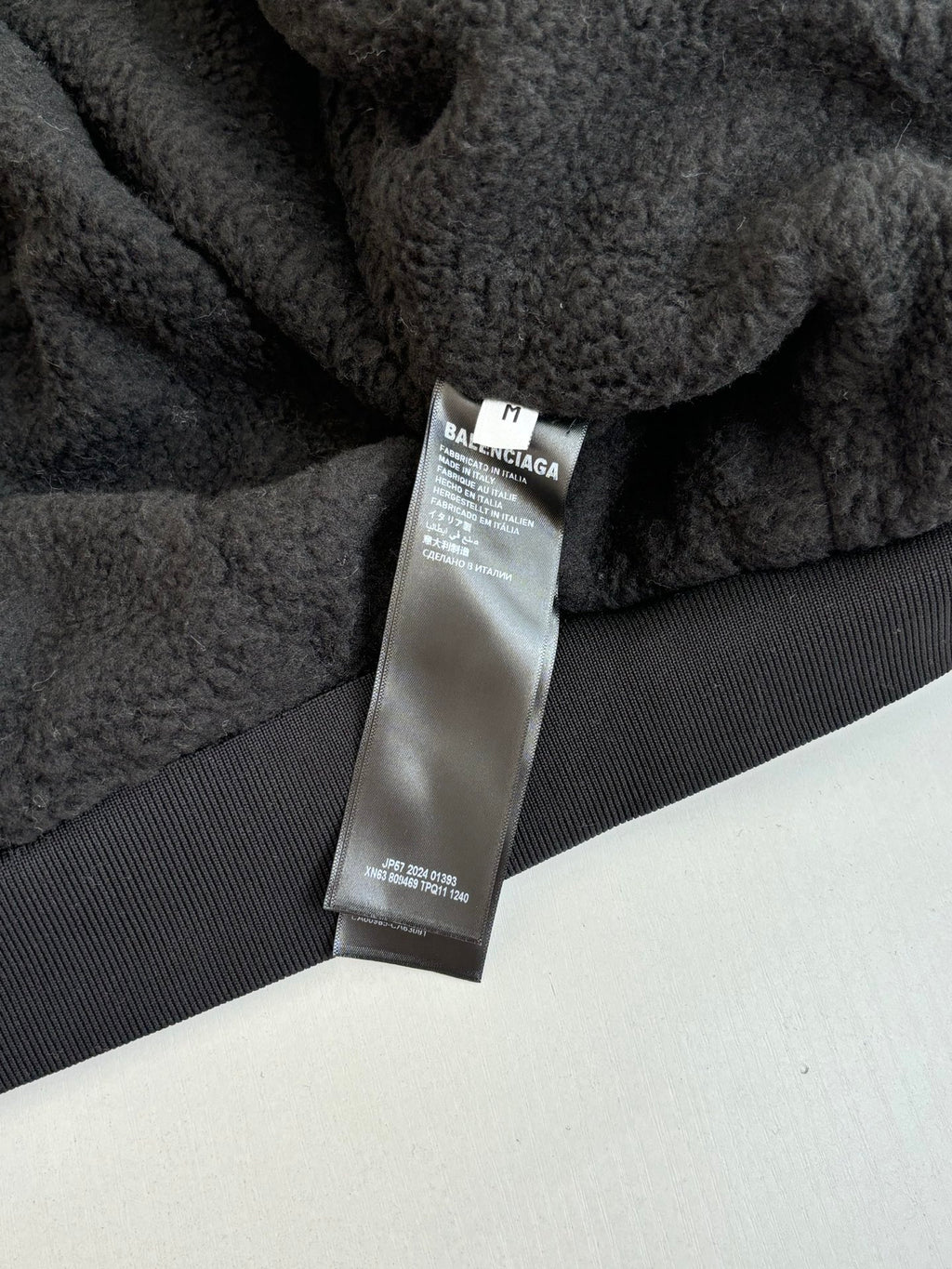 Balenciaga fleece jacket care label on dark interior panel