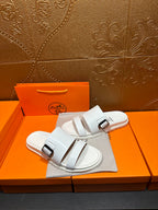 Hermes white slide sandals with two straps and silver buckle hardware