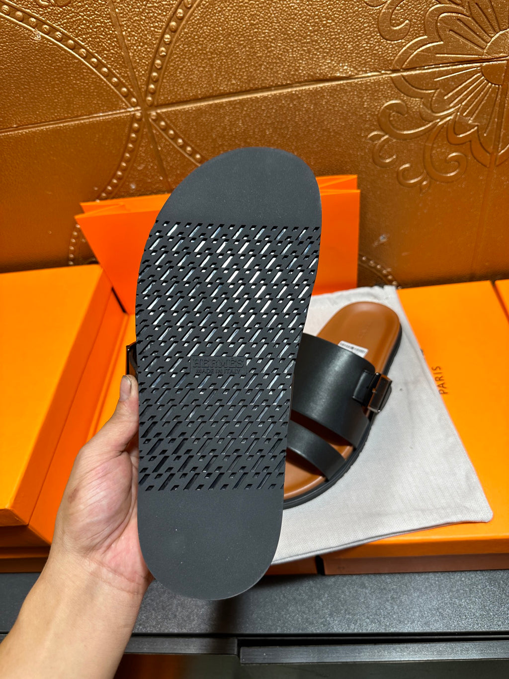 Hermes leather sandals outsole view in black, showing textured tread