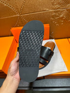 Hermes leather sandals outsole view in black, showing textured tread