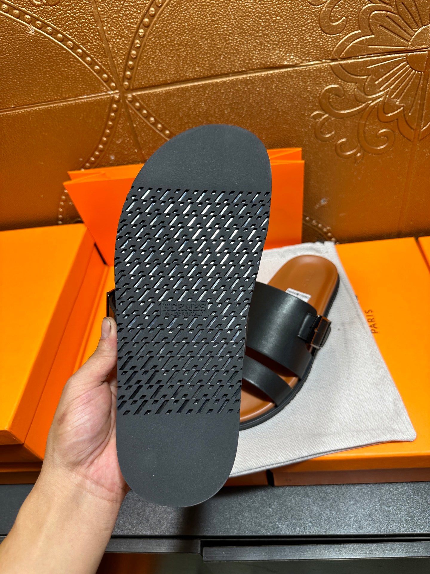 Hermes leather sandals outsole view in black, showing textured tread