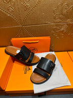 Hermes leather slide sandals, pair view with black straps and buckle, open toe