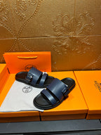 Hermes dark blue sandals with two straps over the foot and buckle closure.