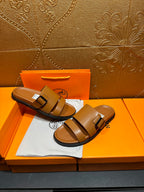 Tan leather slide sandals with two buckle straps, front view