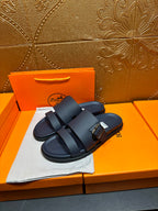 Blue slide sandals with double buckled straps, angled view on display